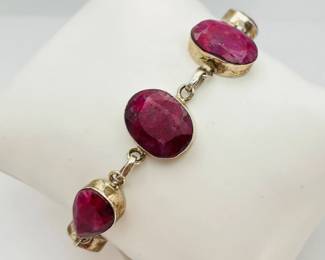 Silver 7" bracelet with (6) faceted red stones that appear to be ruby. 17.18 gtw.