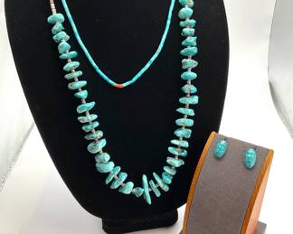 A 26" natural stone turquoise necklace with heishi beads between the stones. Jacla style necklace with turquoise and coral heishi beads. Faux turquoise post earrings.