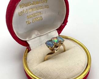 Three (3) oval cut opals are the focal point of this 14K gold ring. Size 7. 3.74 gtw.