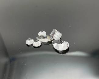 Six (6) white topaz gemstones, mixed shapes and sizes. 3.40 ctw.