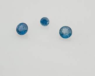 Three (3) round cut blue topaz gemstones. Various sizes. 0.95 ctw.