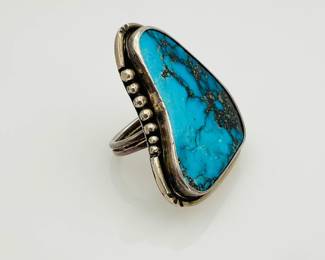 Large 1 3/4" turquoise stone set in silver, signed by the artist. Size 8. 33.31 gtw.