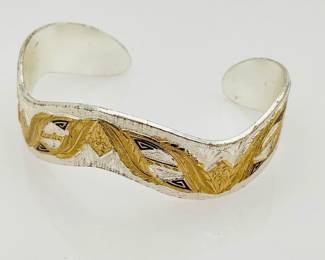 Silver, approximately 5" cuff bracelet. Stamped "Montana Silversmiths" with gold tone accents. 29.43 gtw.
