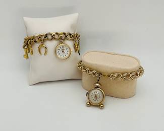 Gold tone charm watch bracelets. One (1) 7" with only the watch face and (1) 6" bracelet with many charms including the watch face. Both watches are "Sheffield".