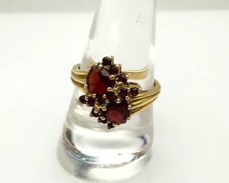 10K gold size 9 ring adorned with (14) red tourmaline stones. Stamped 10K. 3.19 gtw.