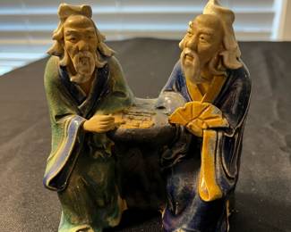 M114 - $25. Mudmen playing a game. Measures 4" wide x 4.5" tall. 