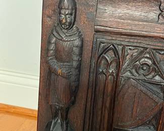 M138 - $275. Gothic Revival Small Chest with Carved Knight Figures. Measures 24.5" wide x 15" deep x 18" tall. 