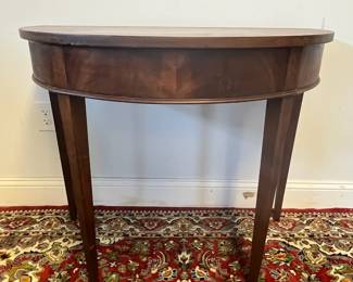 M24 - $60. Demilune Table. Measures 36" wide x 20.5" deep x 29.5" tall. Needs cleaned up/ refinished but it's sturdy, solid wood. 