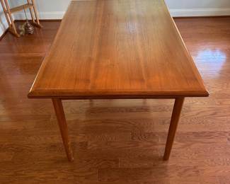 K67 - $300. MCM Teak Hidden Leaf Dining Table. Has some surface wear on top & legs. Overall sturdy. Measures 35" wide x 53" long x 29" tall. 2 leaves pull out and each adds 18"