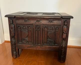 M138 - $275. Gothic Revival Small Chest with Carved Knight Figures. Measures 24.5" wide x 15" deep x 18" tall. 
