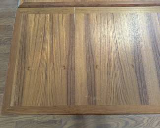 K67 - $300. MCM Teak Hidden Leaf Dining Table. Has some surface wear on top & legs. Overall sturdy. Measures 35" wide x 53" long x 29" tall. 2 leaves pull out and each adds 18"