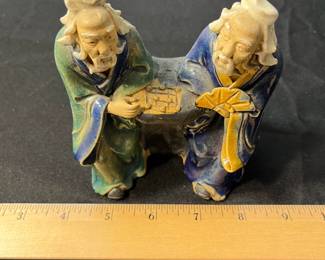 M114 - $25. Mudmen playing a game. Measures 4" wide x 4.5" tall. 