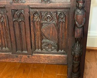 M138 - $275. Gothic Revival Small Chest with Carved Knight Figures. Measures 24.5" wide x 15" deep x 18" tall. 