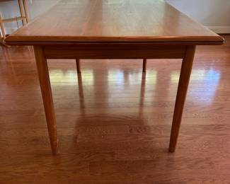 K67 - $300. MCM Teak Hidden Leaf Dining Table. Has some surface wear on top & legs. Overall sturdy. Measures 35" wide x 53" long x 29" tall. 2 leaves pull out and each adds 18"
