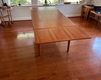 K67 - $300. MCM Teak Hidden Leaf Dining Table. Has some surface wear on top & legs. Overall sturdy. Measures 35" wide x 53" long x 29" tall. 2 leaves pull out and each adds 18"