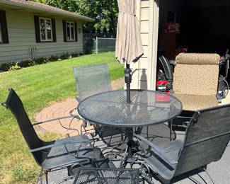 Very nice wrought iron patio table with four chairs, umbrella and cushions for chairs.  Small matching table as well. 