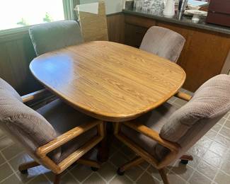 very nice kitchen table with four chairs on castors and one leaf