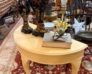 half moon painted table, candlesticks, books