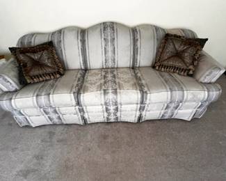 Beautiful, comfortable, floral sofa with decorative pillows.