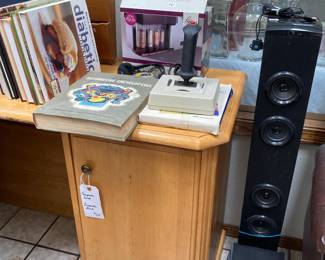 tower speaker, flight simulator game with joystick, coin counter, cookbooks, corner desk