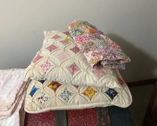 TWO QUILTED PILLOWS AND QUILT PIECE