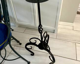 Heavy black wrought iron tall candle holder.