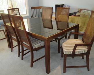 Glass top dining table with 2 leaves. 6 cane back chairs