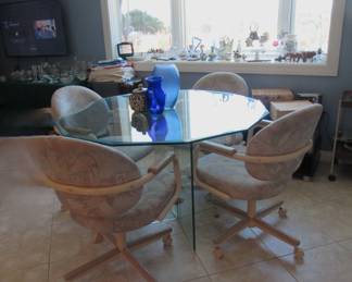 Glass table with 4 chairs on casters
