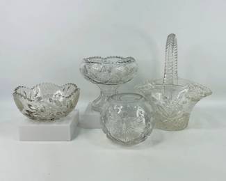 Lot features a selection of vintage cut glass items, including a 13" tall cut glass basket, a pedestal bowl (H 7 1/2" x W 9"), a cut glass rose bowl, and a cut glass bowl. Shipping-YES