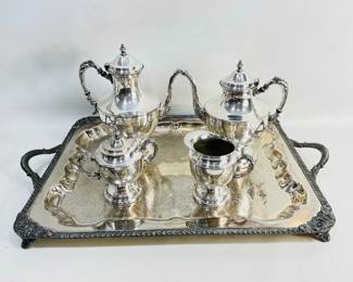 Lot features a classic silver-plated serviceware set stamped "Silver on Copper," including a grand serving tray with ornate detailing (unmarked), two matching tea/coffee pitchers, and a cream and sugar set. Shipping-NO