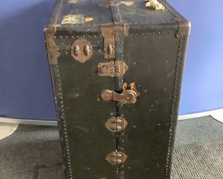 Vintage steamer trunk, H 40" x W 23" x D 23", opens to reveal (5) drawers on one side and a compartment with 7 hangers on the other. Outside has broken lock, one broken latch, repaired handles, and multiple area with missing and cracked finish as well as markings and wear and tear from use and age. See photos for more details. Shipping-NO