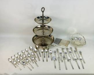 This lot features a 3-tier hammered stainless steel serving tray, a beautifully detailed HKE Wurtemberg silver-plated pierced filigree basket, and a classic set of Community "Coronation" silver plate flatware Shipping-NO