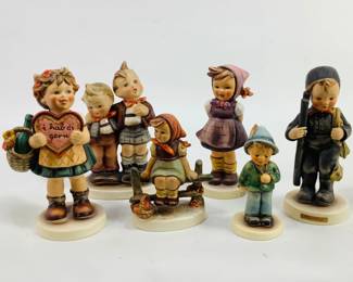 An assortment of (6) Hummel figurines ranging from 3 1/2" to 6 1/2" in height. Assortment includes: "The Chimney Sweep" #12/1, "Valentine's Gift" #387, Max and Moritz #123 and more. Most figurines have crazing and the girl sitting on the fence has a large chip on her hair. See photos for details. Shipping-YES