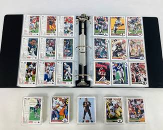Two (2) sets of 1991 Upper Deck NFL trading cards (#1-500). One set is stored in a binder in Pro pages, and the other set is in plastic trading card boxes. Shipping-YES