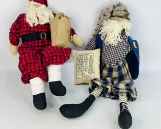 Handcrafted Fabric Santas: (1) folk-style Santa wearing checkered and plaid clothing in blue and beige tones with a vest with applique moon and star, a long beard made of yarn and a knitted hat, (1) is wearing a blue and red plaid outfit with matching hat and black boots carrying a burlap bag, and (1) small pillow with a Luke 2:10 Bible verse stitched on it.