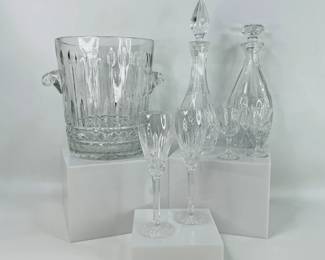 Waterford Crystal Glasses & Cut Glass Barware. Includes a pair of Waterford Crystal Ballymore fluted wine glasses, a pair of Cristal D'Arques- Durand Flammes Cordial Glass, (1) large cut glass ice bucket (small chip on base), H 9 1/2" x W 11", and (2) cut glass decanters. Shipping-NO