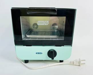 Dash mini toaster oven in aqua, H 7 1/2" x W 7 1/2" x D 6", one slice capacity. Model DMTO100GBAQ04. Powers on. Like new condition. Shipping-YES