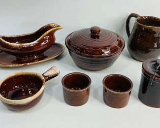 Brown Crockware. (1) Marcrest Stoneware covered casserole W 8 1/2", (1) Pitcher H 6", (1) Hull gravy boat with plate W 10 1/2", (1) McCoy soup bowl, (1) 5" crock with lid, (2) small bowls. Shipping-YES