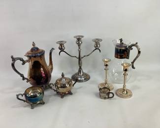 Silver Plate Tablewares. Lot includes a silver plate coffee/tea pot, vintage Corning thermal glass carafe with silver plate handle and lid, silver plate cream and sugar set, and a pair of silver plate candle holders. Shipping-YES