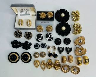 15 +/- pairs of clip-on earrings in gold and black, many with rhinestone accents Sizes range from 1" - 2 1/2" diameter. Faux pearl missing from one earring. Shipping-YES