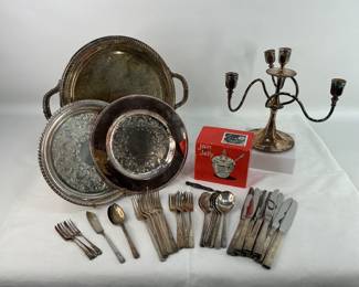 Serving Trays, Flatware, & more. Includes an antique Sterling nail file #3905, 19.61g, (3) WM Rogers silver-plated serving trays, a Simpson, Hall, Muller & Co. candelabra, a set of vintage Oneida "Grenoble" Prestige silver-plated flatware, and a WM Rogers silver-plated "Jam 'n Jelly" set. Shipping-NO