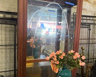 Glass cabinet.  Floral arrangement 