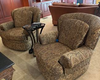 Pair of Upholstered Swivel Chairs – Comfortable and stylish chairs in a neutral paisley fabric with warm brown tones. Smooth swivel base offers flexibility for conversation or lounging. Upholstery in excellent condition, making them a versatile addition to a living room, den, or home office.