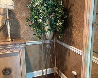 Tall Decorative Ivy Arrangement – Elegant faux ivy arrangement in a metallic urn planter, set on a tall sculptural metal stand. Adds greenery and sophistication to any corner without the maintenance of live plants.