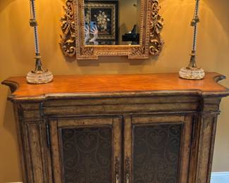 Ambella Console Table – High-end Ambella console in a warm wood finish with decorative metal inlay doors and elegant carved details. Stylish and versatile, ideal for an entryway, dining room, or living space.