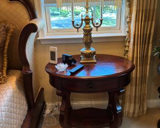Century Nightstand – Elegant round wood nightstand with a rich finish, curved silhouette, and carved details. Features a single drawer with decorative pull and an open lower shelf for display or storage. Classic and timeless design, pairs beautifully with both traditional and transitional bedroom décor. Excellent condition.
