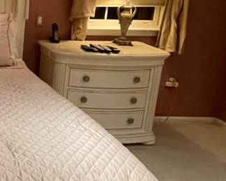 Stanley Nightstand – Elegant cream-finished nightstand with curved front, fluted detail, and two spacious drawers. Coordinates with the Stanley dresser, mirror, and chest (also available).
