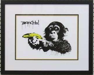 9075 - CHIMP WITH BANANA GUN BY GRAFFITI ARTIST BANKSY 21.5 X 17

