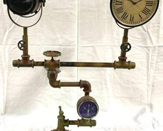 9502 - Industrial Style Floor Lamp/Clock by Alma Artte 34.5 x 25 x 8 Made from old discarded piece of water pump - one side has a clock and the other side has a lamp. Consigned by wholesaler / distributor, untested, no warranties.
