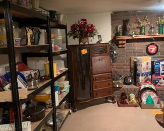 Antique secretary, used as a gun cabinet,
Tupperware iron skillets, baking dishes